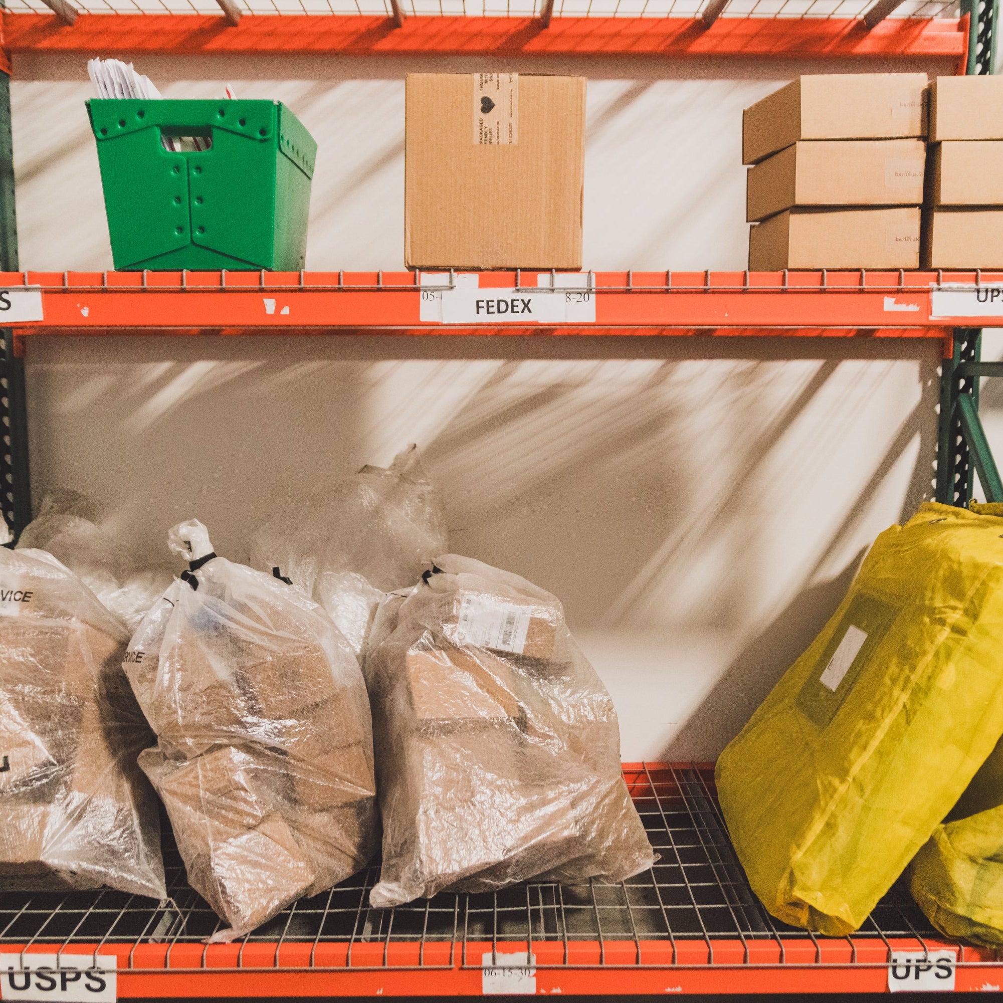 Collective Pallet outbound shipping area with labeled USPS, UPS, and FedEx carrier zones prepared for international DDP shipping and ecommerce order fulfillment.