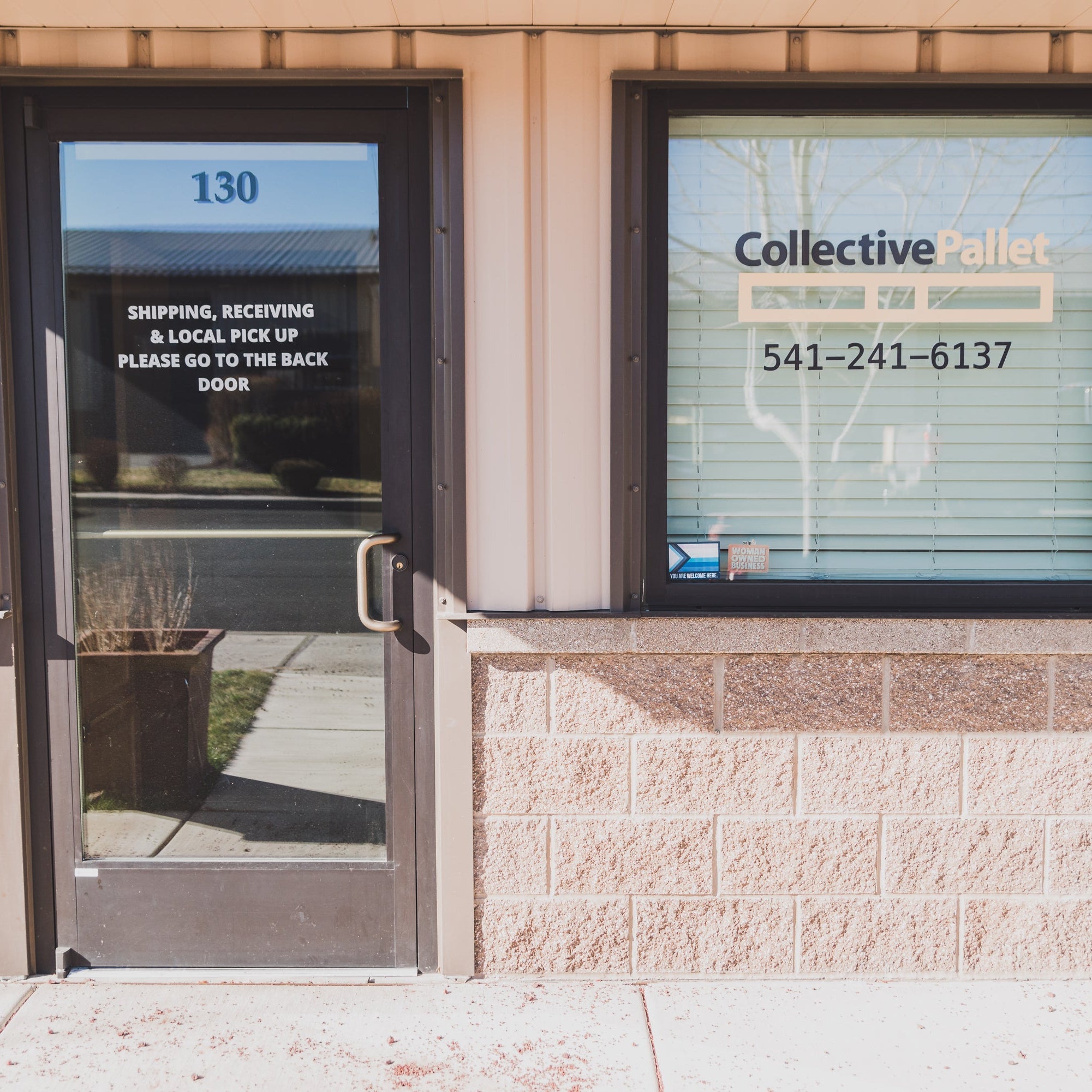 Exterior entrance of the Collective Pallet warehouse featuring local pickup and shipping signage at the Bend, Oregon fulfillment facility.