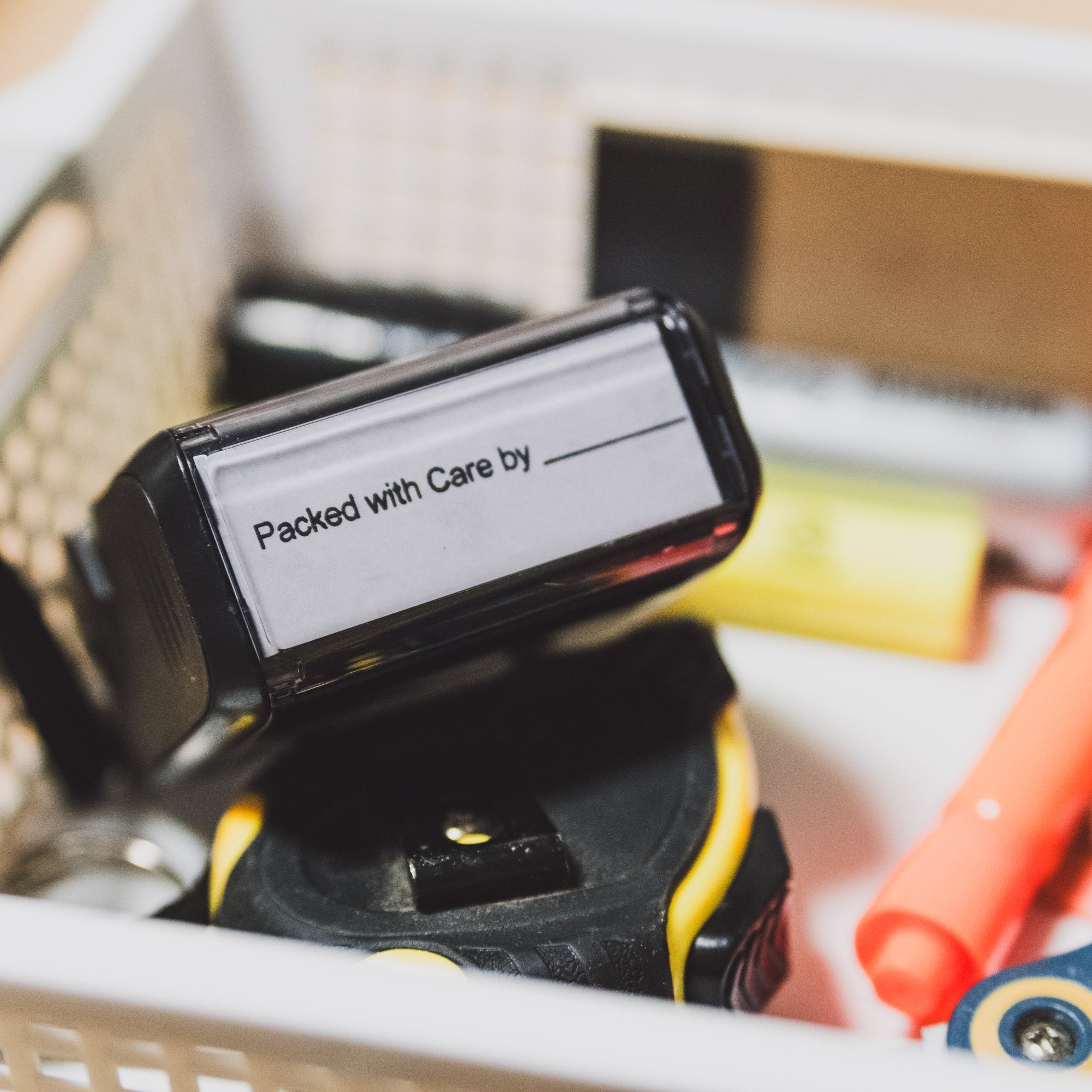 Close-up of a Collective Pallet packing station tool labeled “Packed with Care,” highlighting attention to detail for kitting and assembly projects.